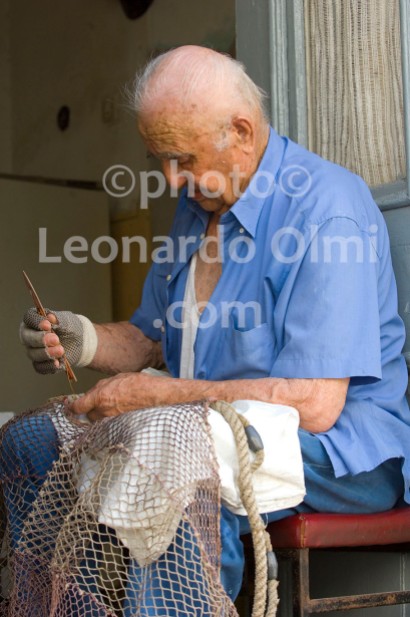 Fisherman repearing his fishing net, Stari Grad; Hvar island; Croatia
